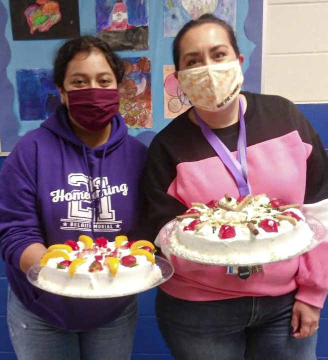 Two individuals holding cakes