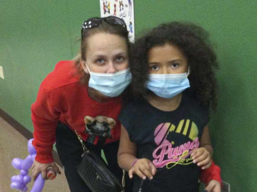 Adult and student posing for a picture together