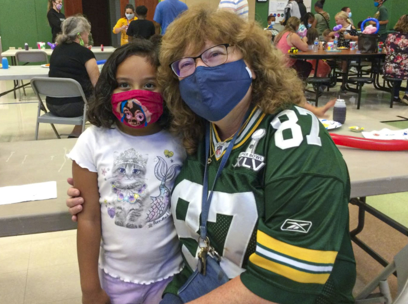 Woman and little girl posing for a picture together