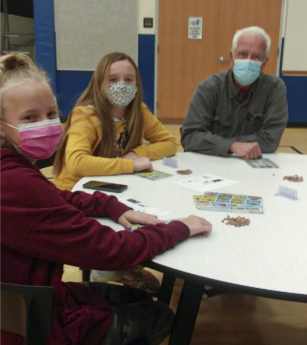 Student and adult playing loteria game