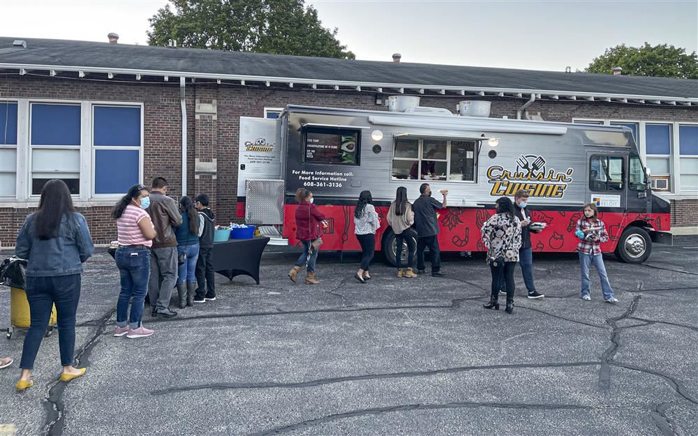 People picking up food from a food truck