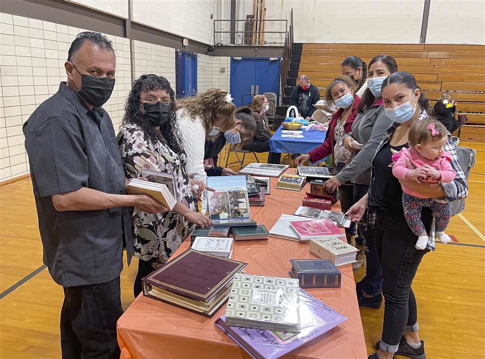 People looking at photo albums on a table