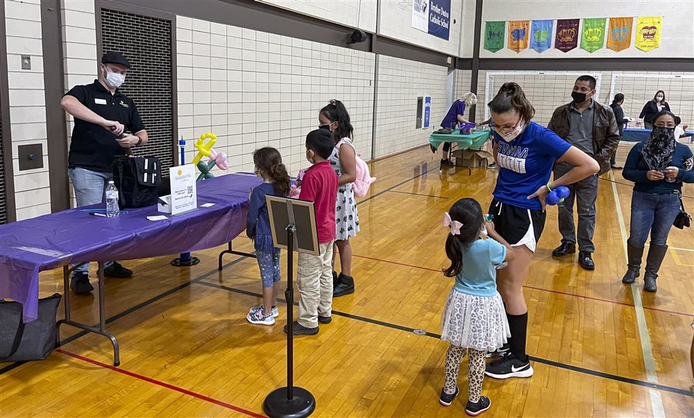 Kids lined up to receive a balloon animal