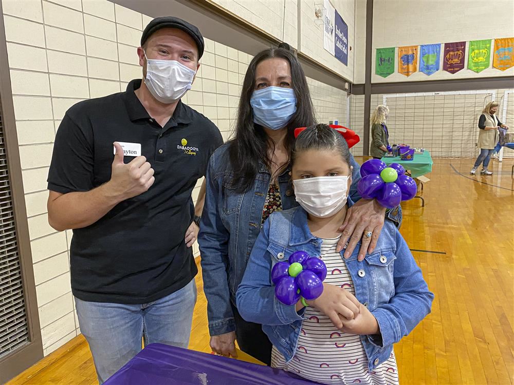 Two adults and a child posing for a photo