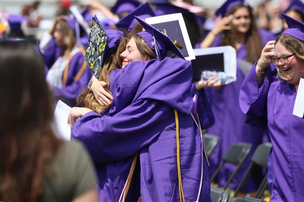 Graduation Picture - students hugging after graduating
