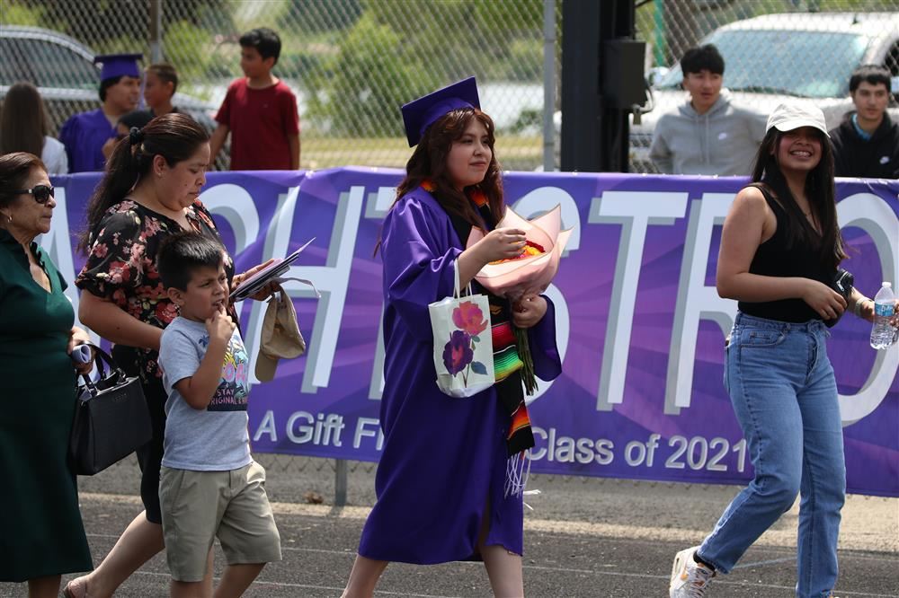 Graduation picture - student walking with family