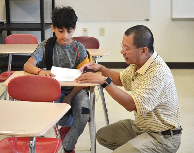  Police Officer helping a Student with a Study Guide