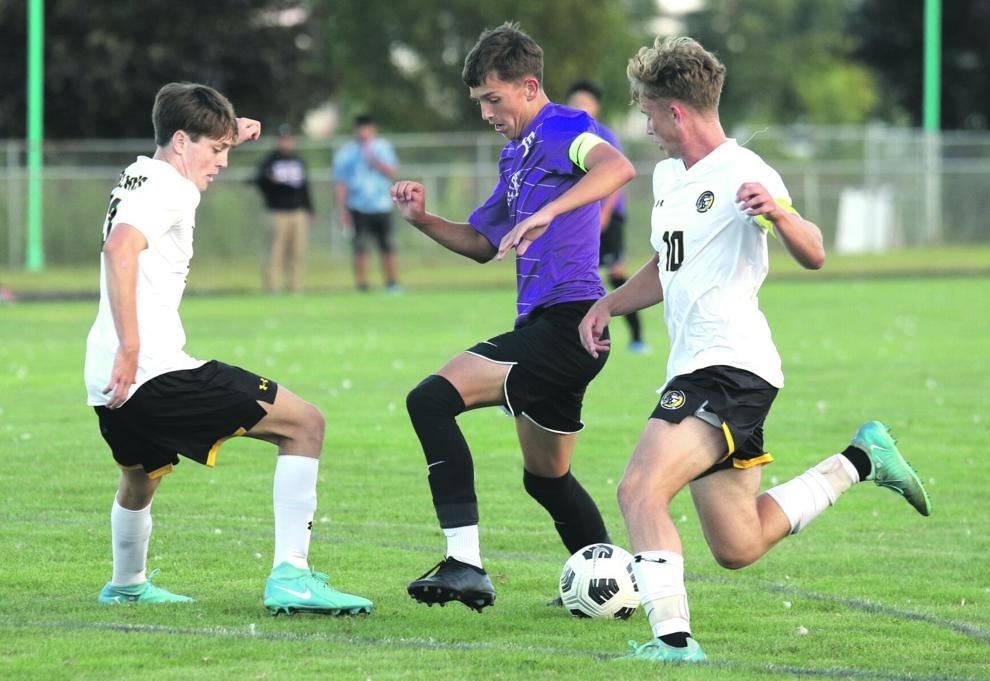 Beloit Memorial’s Banks Denu, middle, tries to beat a double-team against East Troy Tuesday night.