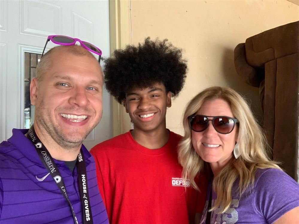 Staff and student smiling 